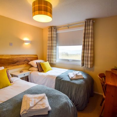 Our twin or superking bedroom with sea view at Port Beag Chalets, Altandhu