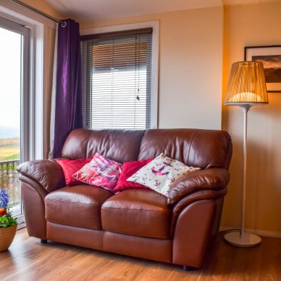 Our lounge with patio doors leading to outside decking at our Rowan Cottage, Port Beag Holidays