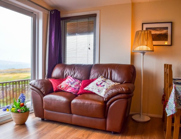 Our lounge with patio doors leading to outside decking at our Rowan Cottage, Port Beag Holidays